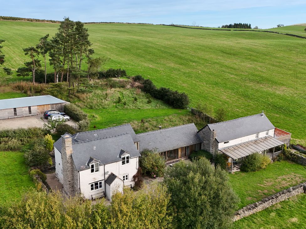 A house with a shed and car in an outdoor setting at Pant Dafydd Goch in Llangollen