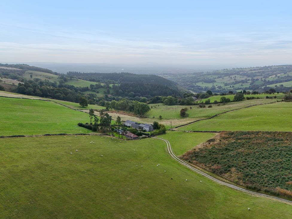 A rural landscape with a house and sheep at Pant Dafydd Goch in Llangollen