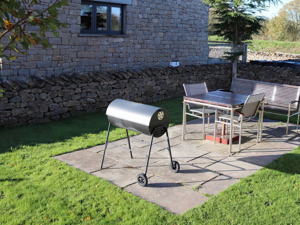 A garden with a grill and seating at Boavista in Carnforth
