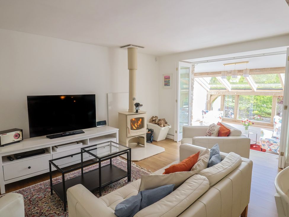 A living room with a television and sofa at Pottery Barn in Branscombe