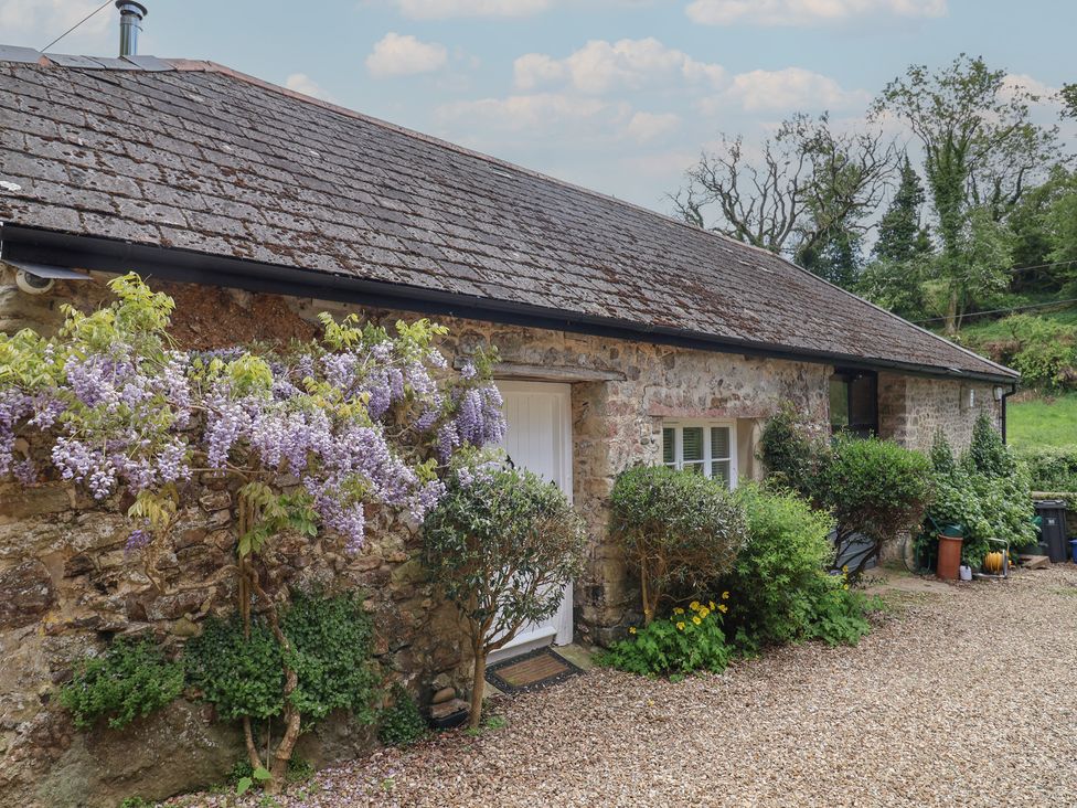 An exterior view of a stone building with plants at Pottery Barn in Branscombe