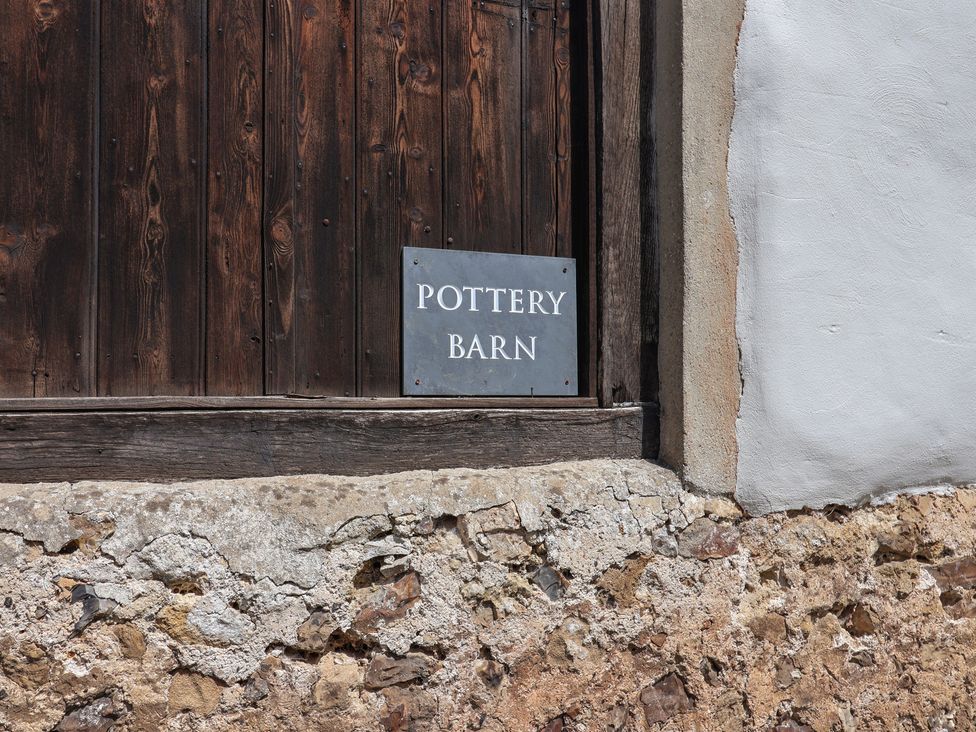 A sign that says Pottery Barn near a wooden wall at Pottery Barn Branscombe
