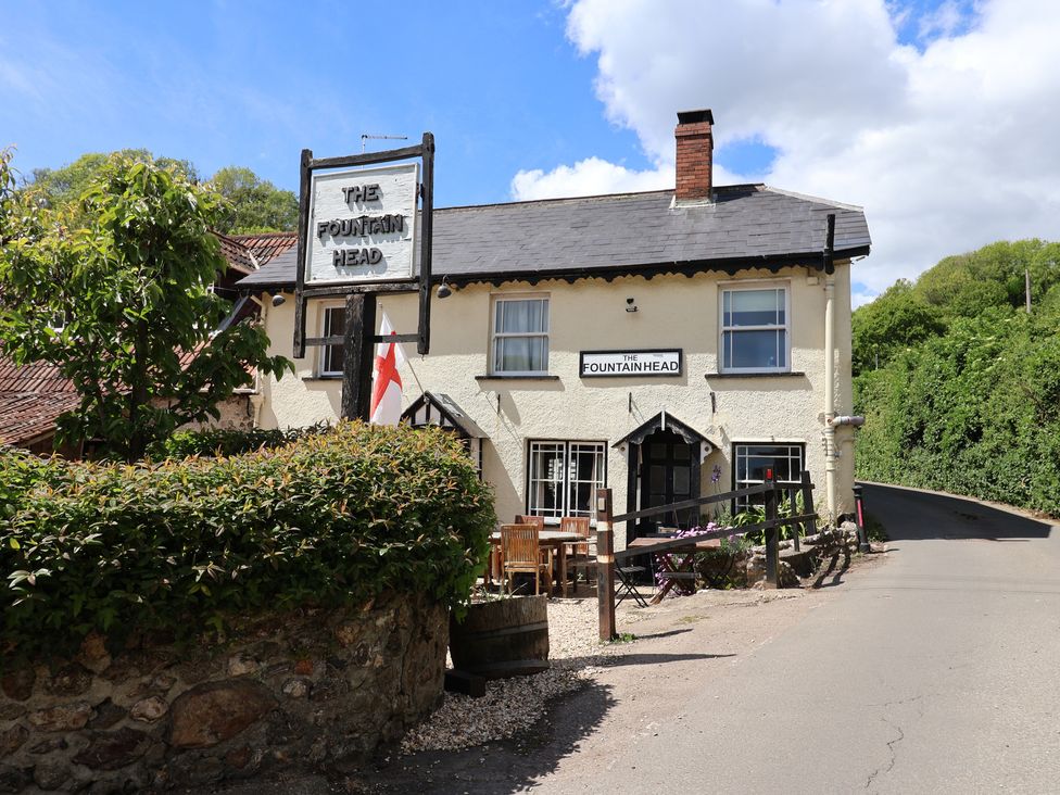 A building with a sign at The Fountain Head in Branscombe