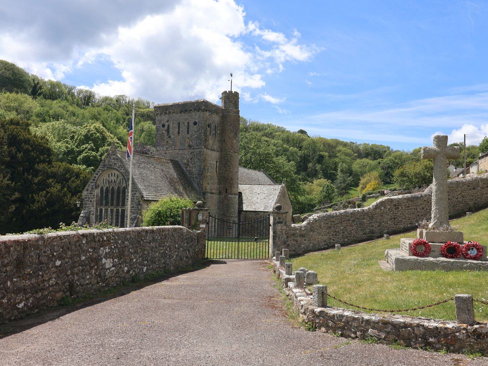 A church with a memorial and flag in Branscombe at Pottery Barn