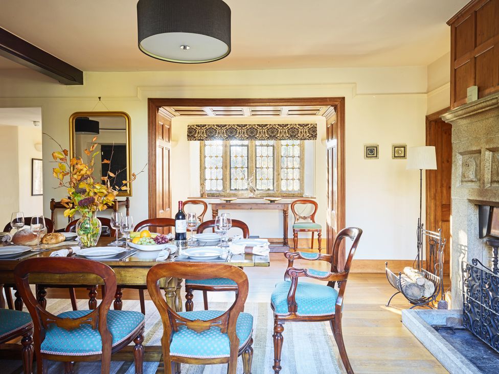 A dining room with a table set for a meal at Great Bidlake Manor in Bridestowe, near Lydford