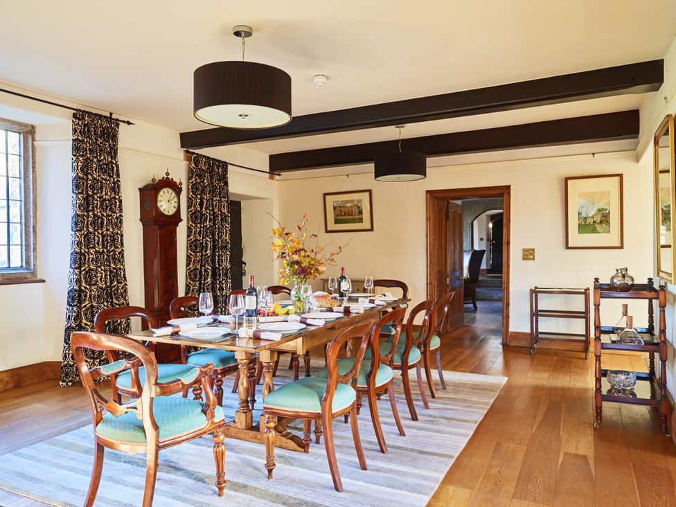 A dining room with a table and chairs at Great Bidlake Manor in Bridestowe, near Lydford