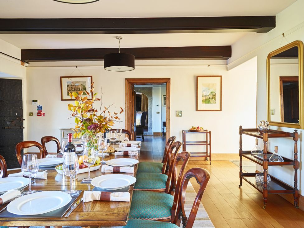A dining room with a large table set for a meal at Great Bidlake Manor, Bridestowe, near Lydford