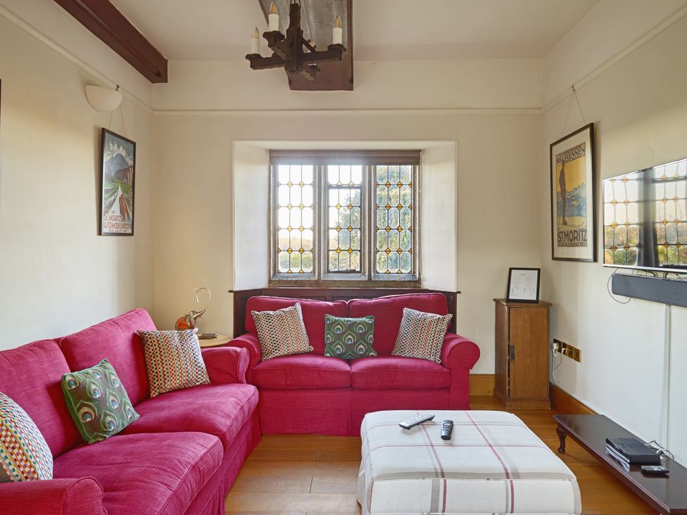 A living room with a sofa and coffee table at Great Bidlake Manor, Bridestowe, near Lydford