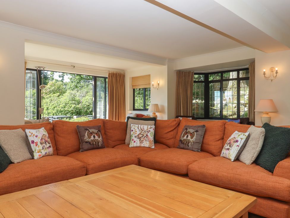 A living room with a sofa and coffee table at Sandsgate near Spinster's Rock, near Chagford