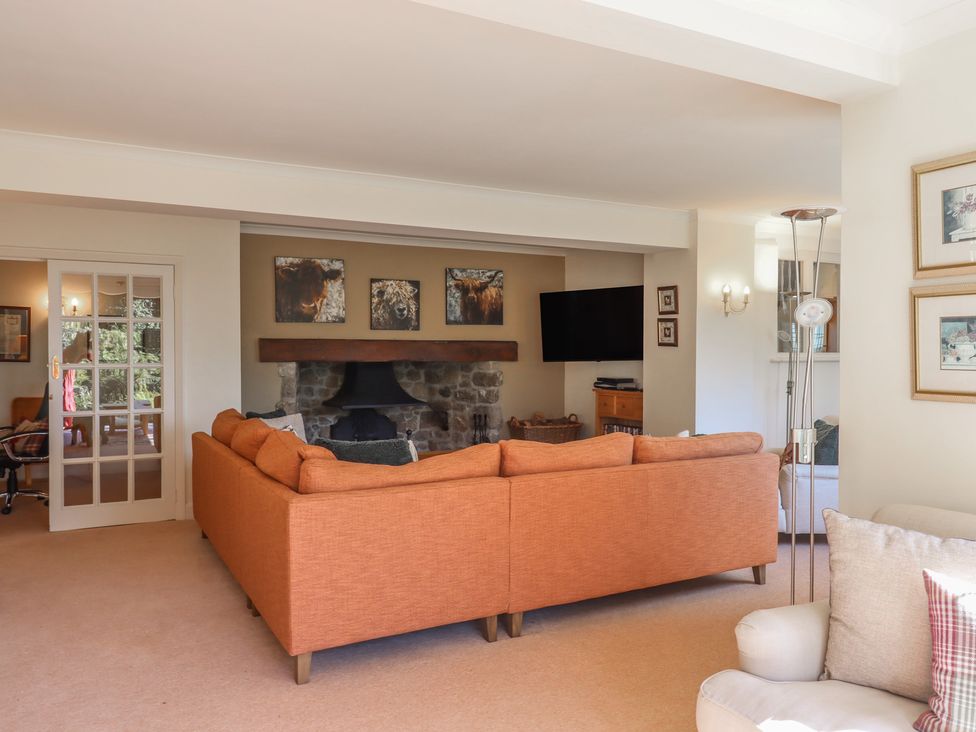 A living room with a sofa and fireplace at Sandsgate near Spinster's Rock, near Chagford