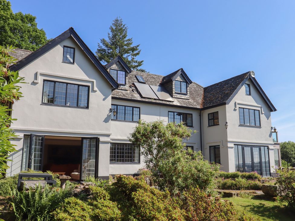 An exterior view of a house with windows and landscaping at Sandsgate near Chagford