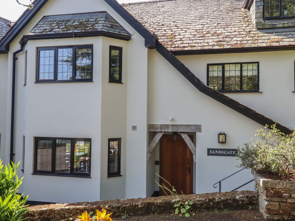 The exterior of Sandsgate with windows and a door at Spinster's Rock, near Chagford