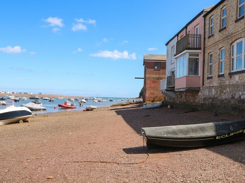 A view of boats at the shore by a building at The Dolphins in Shaldon