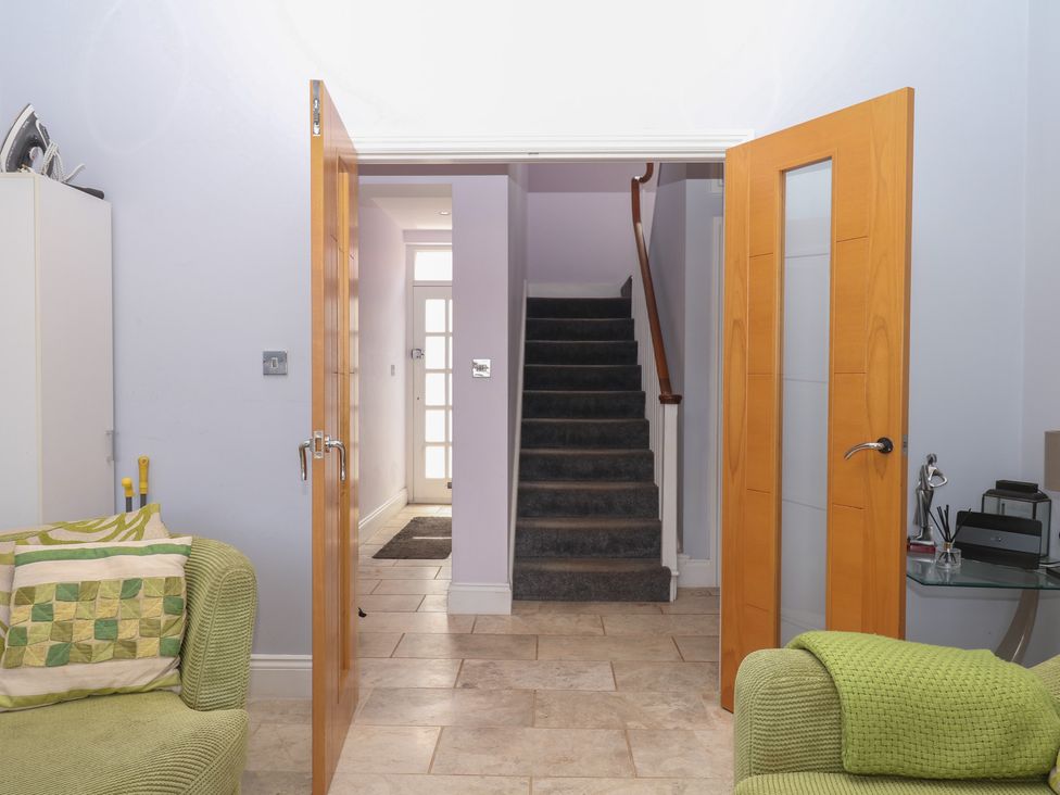 A hallway with a staircase and seating area at The Dolphins in Shaldon