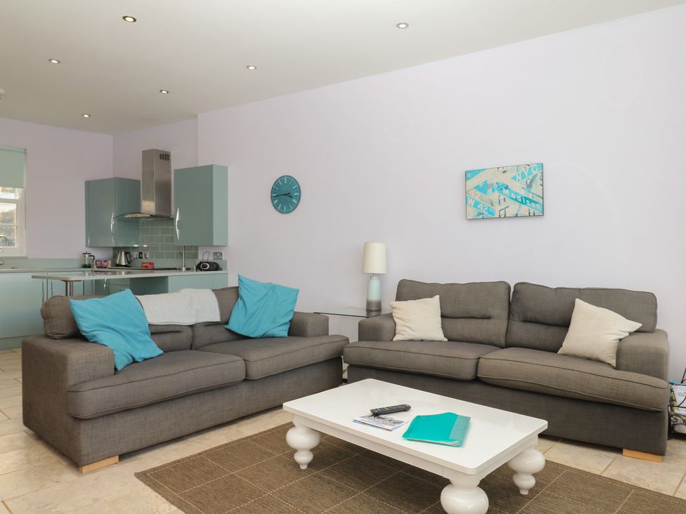 A living room with a sofa and coffee table at The Dolphins in Shaldon