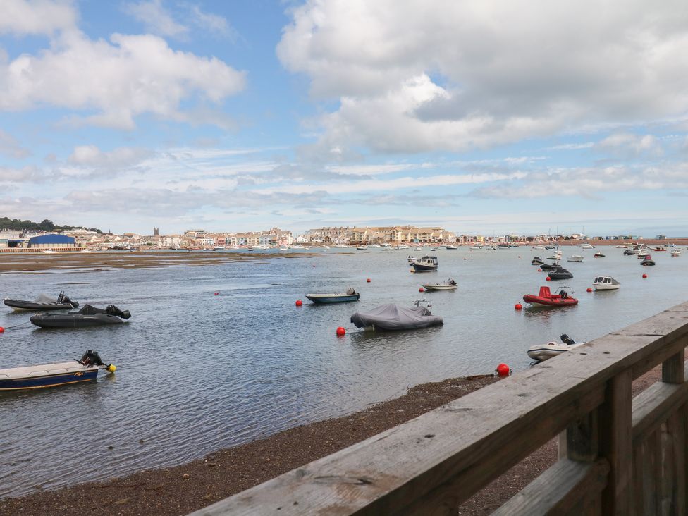 A view of boats on water with a shoreline at The Dolphins in Shaldon