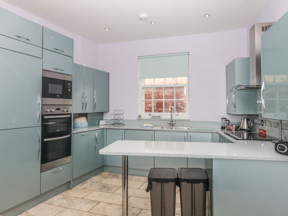 A kitchen with cabinets and appliances at The Dolphins in Shaldon
