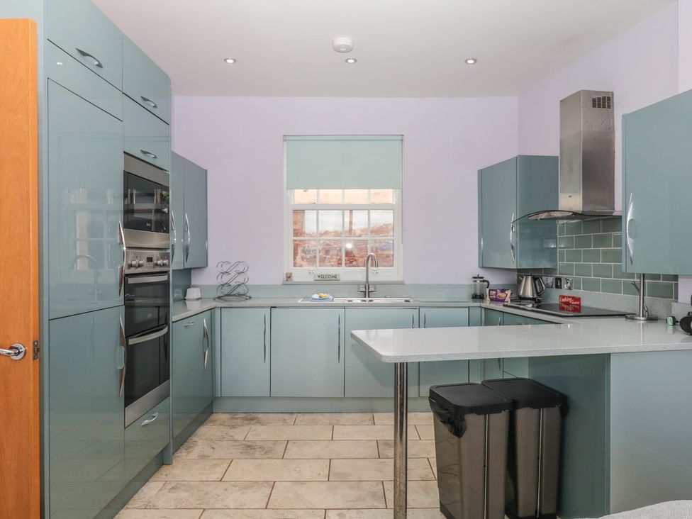 A kitchen with cabinets and appliances at The Dolphins in Shaldon