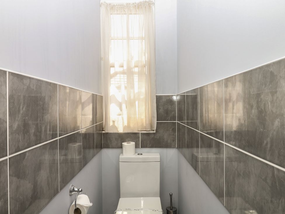 A bathroom with a toilet and window at The Dolphins in Shaldon