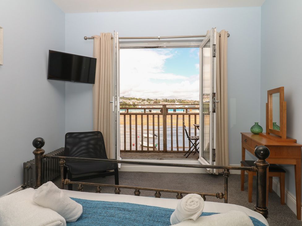 A bedroom with a bed and television at The Dolphins in Shaldon
