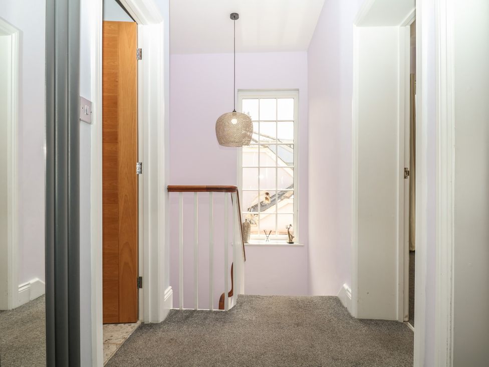 A hallway with a window and doors at The Dolphins in Shaldon