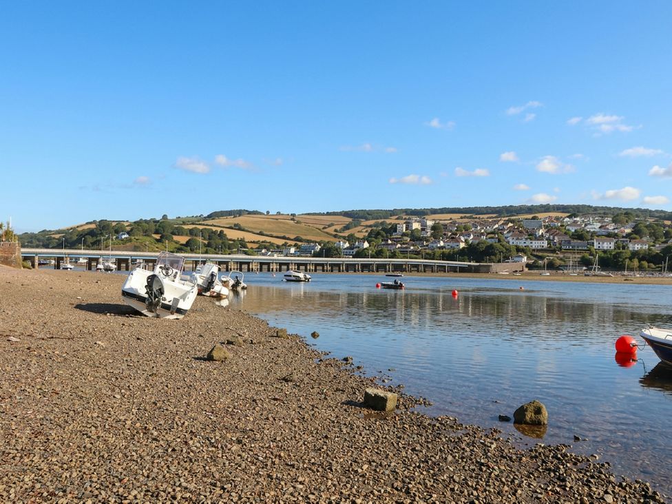 A river with boats and a bridge visible at The Dolphins in Shaldon