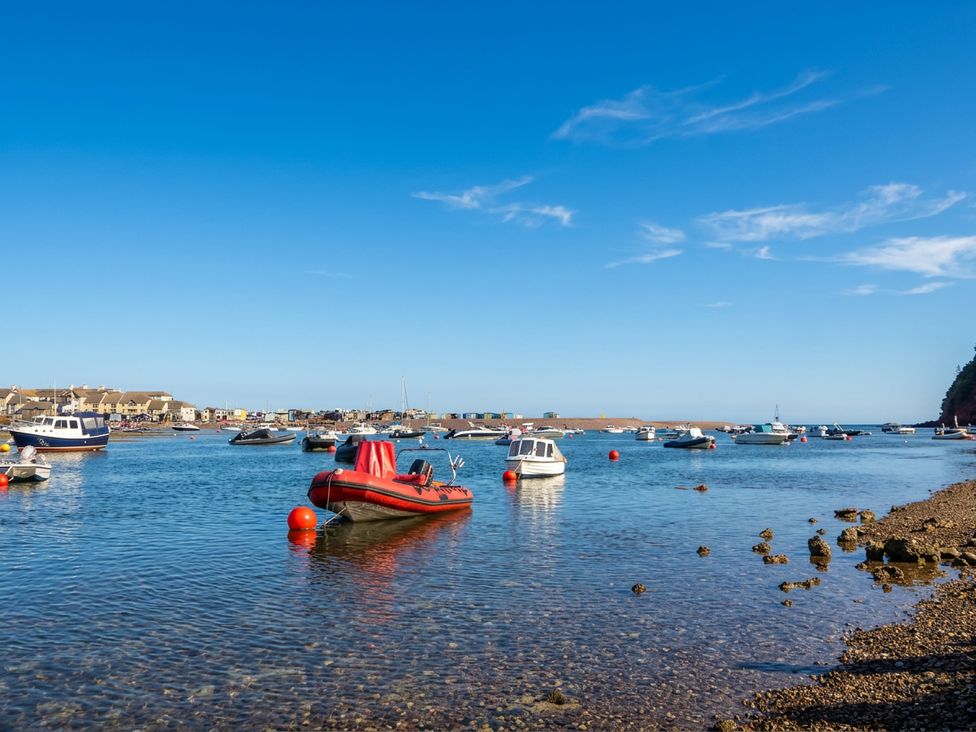 A view of boats in water with houses in the background at The Dolphins in Shaldon