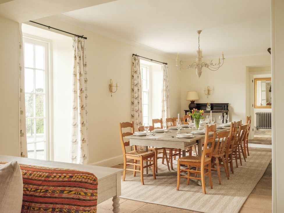 A dining room with a large table and chairs at Sandridge Barton in Stoke Gabriel