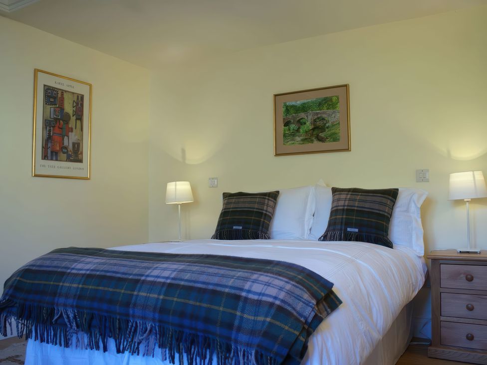 A bedroom with a bed and bedside lamps at The Barn in Compton Bishop, near Cheddar