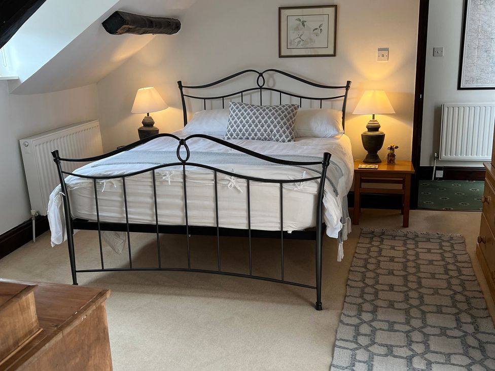 A bedroom with a bed and bedside lamps at Castle View in Dunster