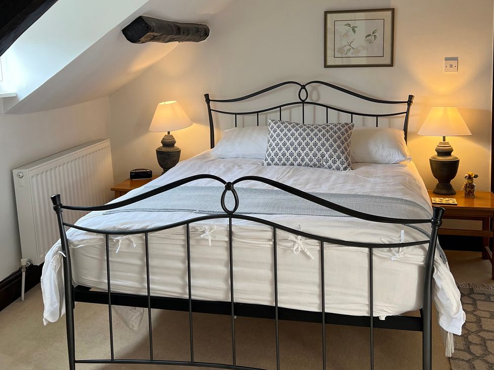 A bedroom with a bed and bedside lamps at Castle View in Dunster