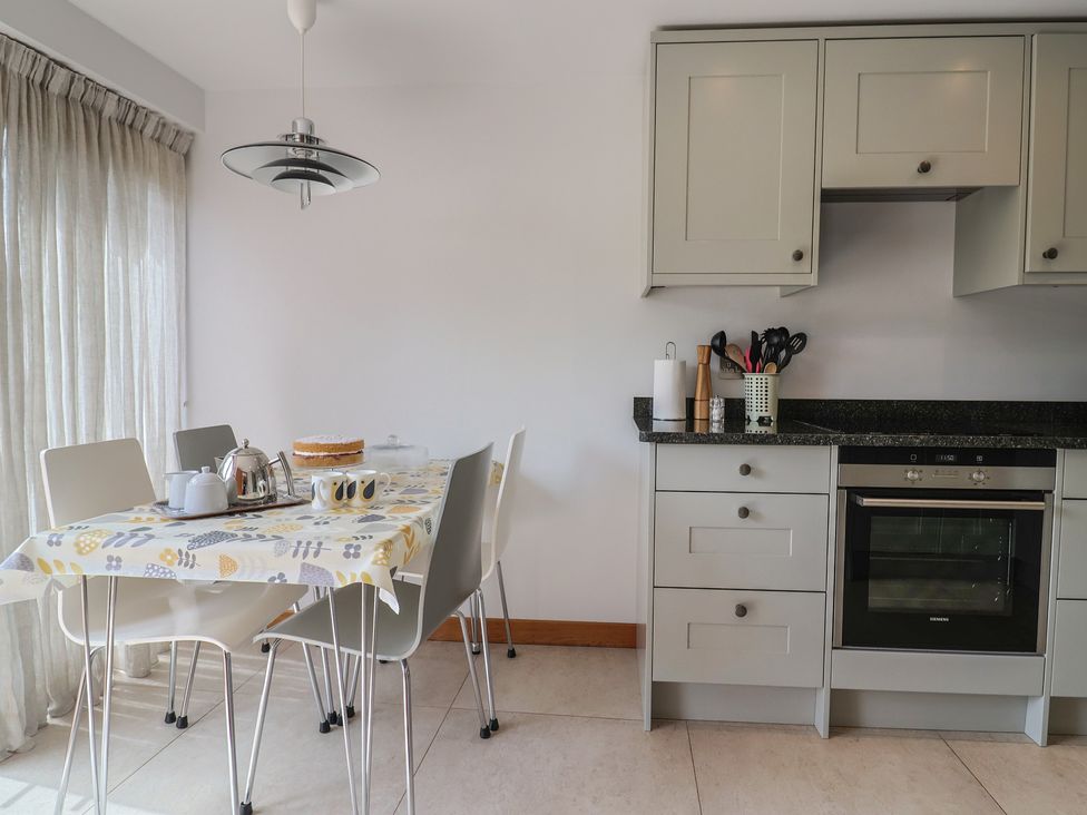 A kitchen with a table set for tea at The Old Log Shed in Honiton