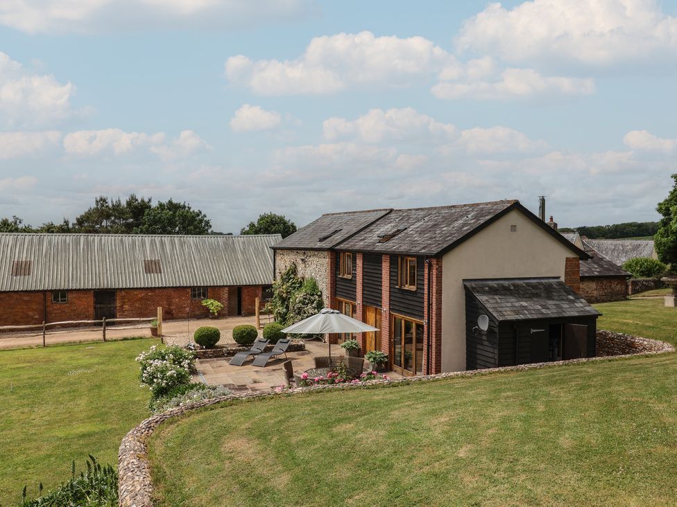 A house with patio and garden area at The Old Log Shed in Honiton