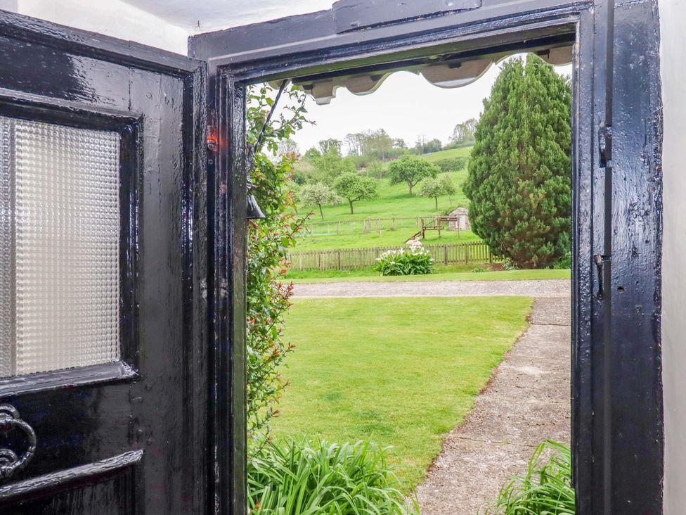 A view from a doorway showing a field and trees at Hornshayne Farmhouse, Farway, near Honiton