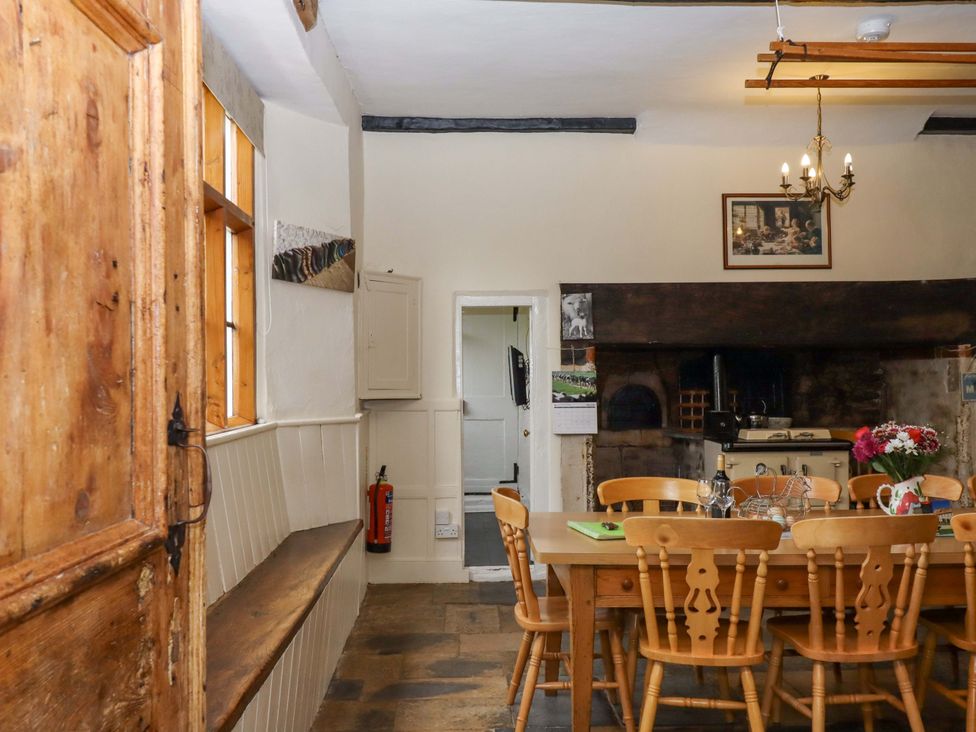 A kitchen with a dining table and chairs at Hornshayne Farmhouse, Farway, near Honiton