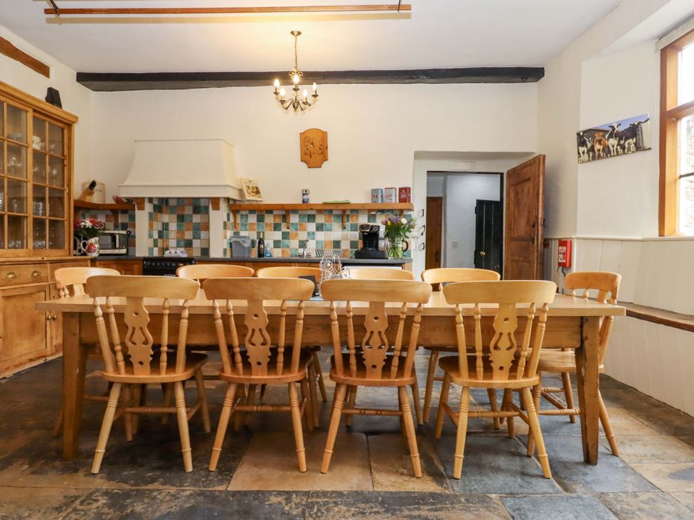 A kitchen with a wooden table and chairs at Hornshayne Farmhouse in Farway, near Honiton