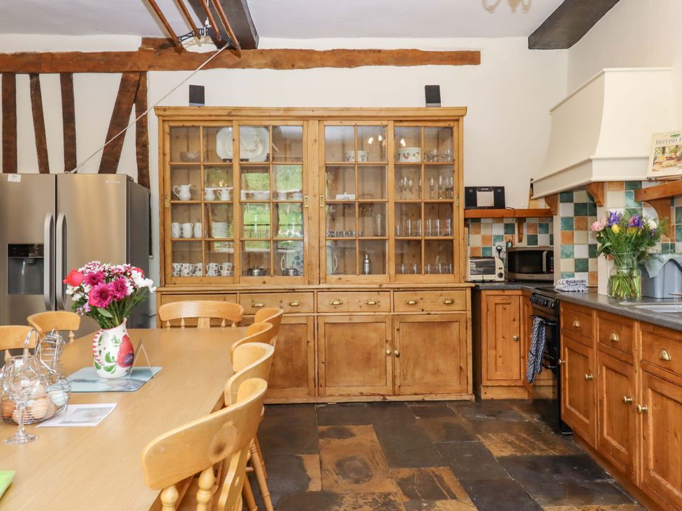 A kitchen with a wooden table and chairs at Hornshayne Farmhouse, Farway, near Honiton