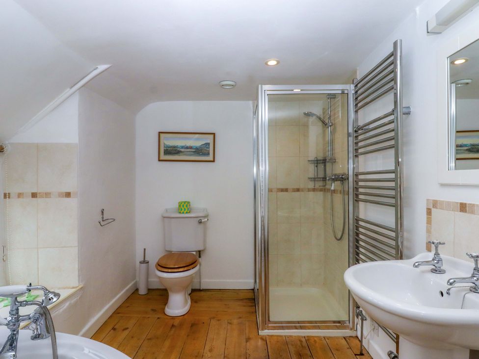 A bathroom with a shower, toilet, and sink at Hornshayne Farmhouse in Farway, near Honiton