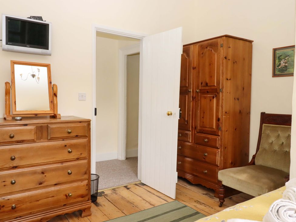 A bedroom with a chest of drawers and wardrobe at Hornshayne Farmhouse Farway near Honiton
