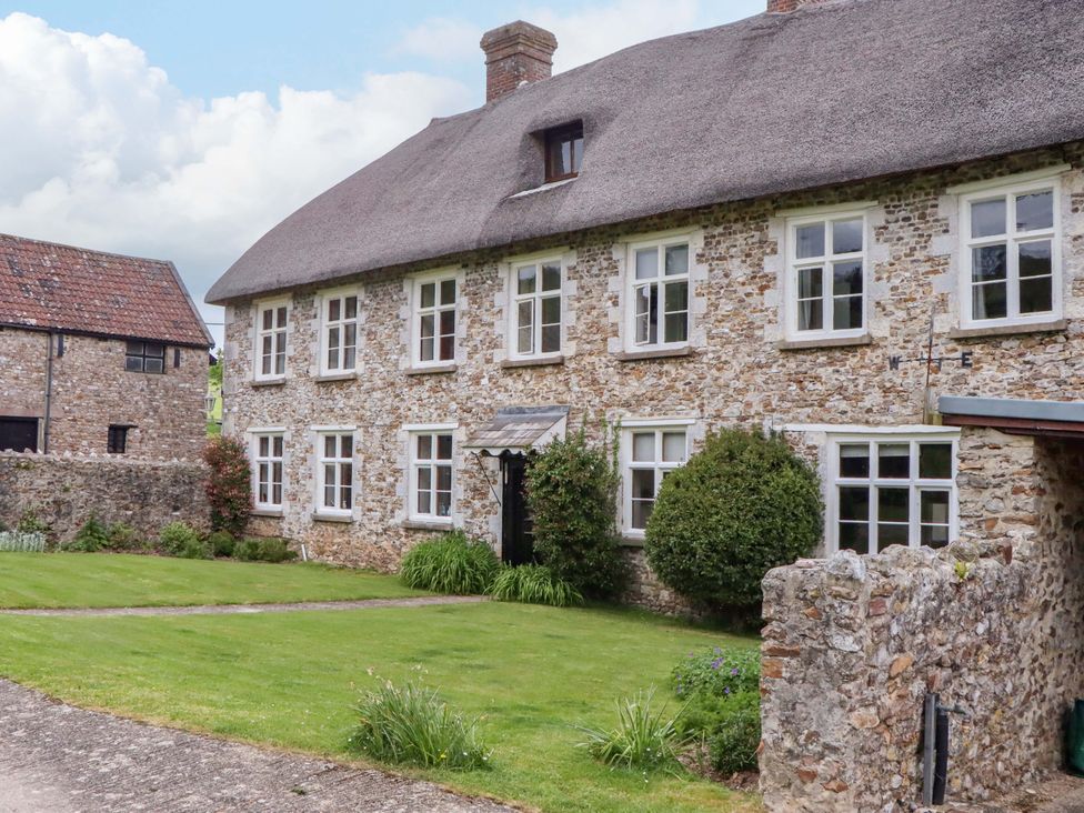 A house with windows and a garden at Hornshayne Farmhouse, Farway, near Honiton