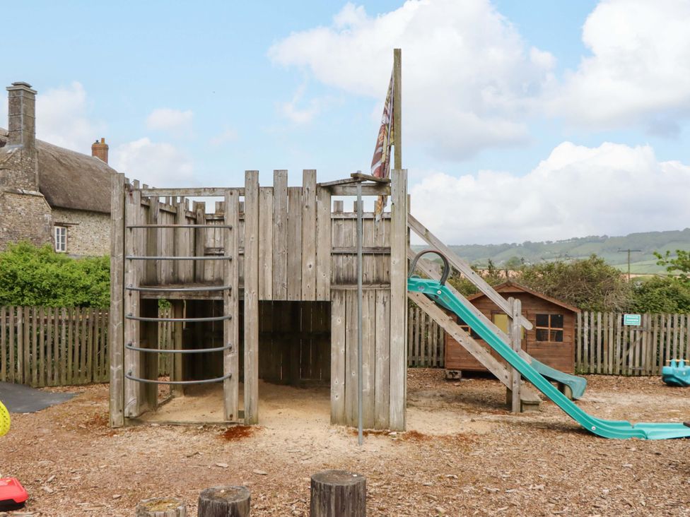 A play structure with a slide and climbing frame at Hornshayne Farmhouse in Farway, near Honiton