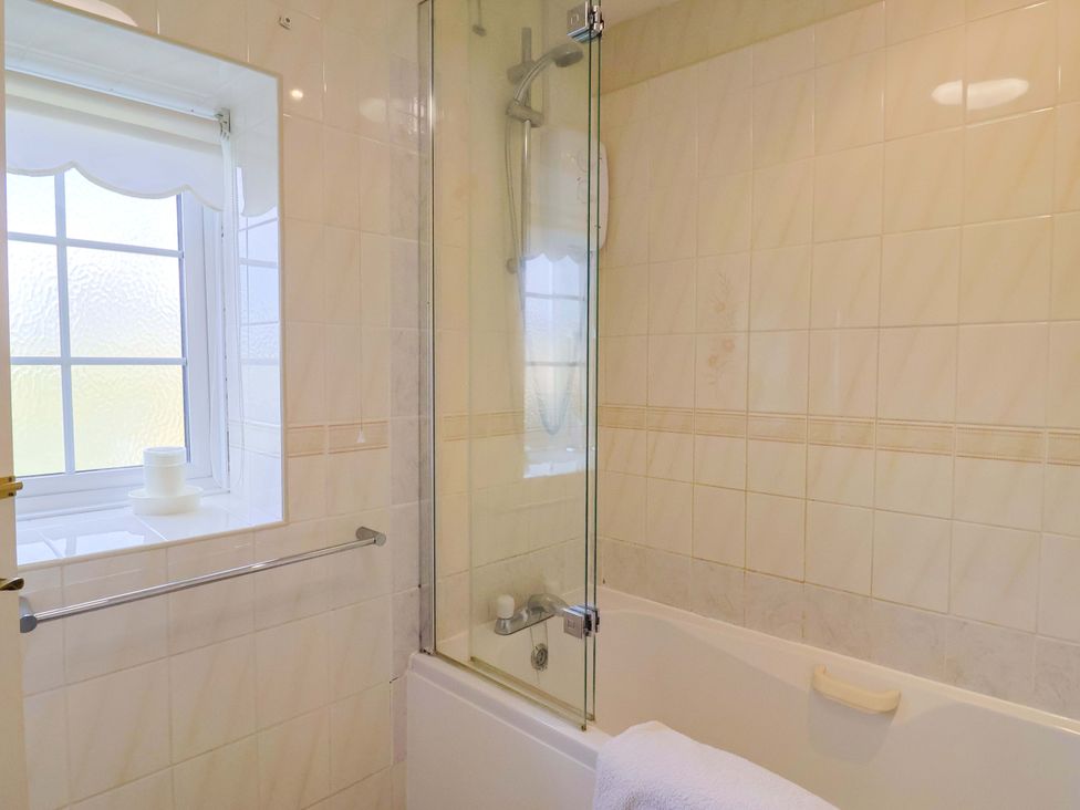 A bathroom with a bath tub and shower at Poppy Cottage Charlton Marshall