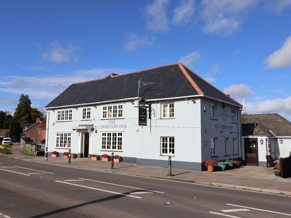 A building facade with a sign at The Charlton Inn in Charlton Marshall