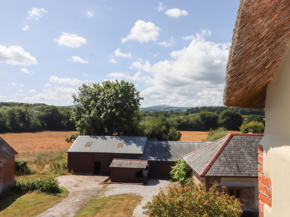 A view of fields and barns from above at The Cottage in Sampford Courtenay