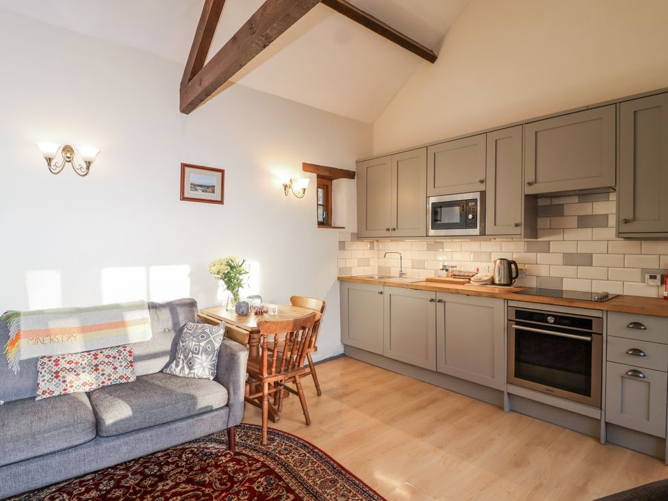 A kitchen with seating area and dining table at Miners Dry, Gulworthy, near Tavistock