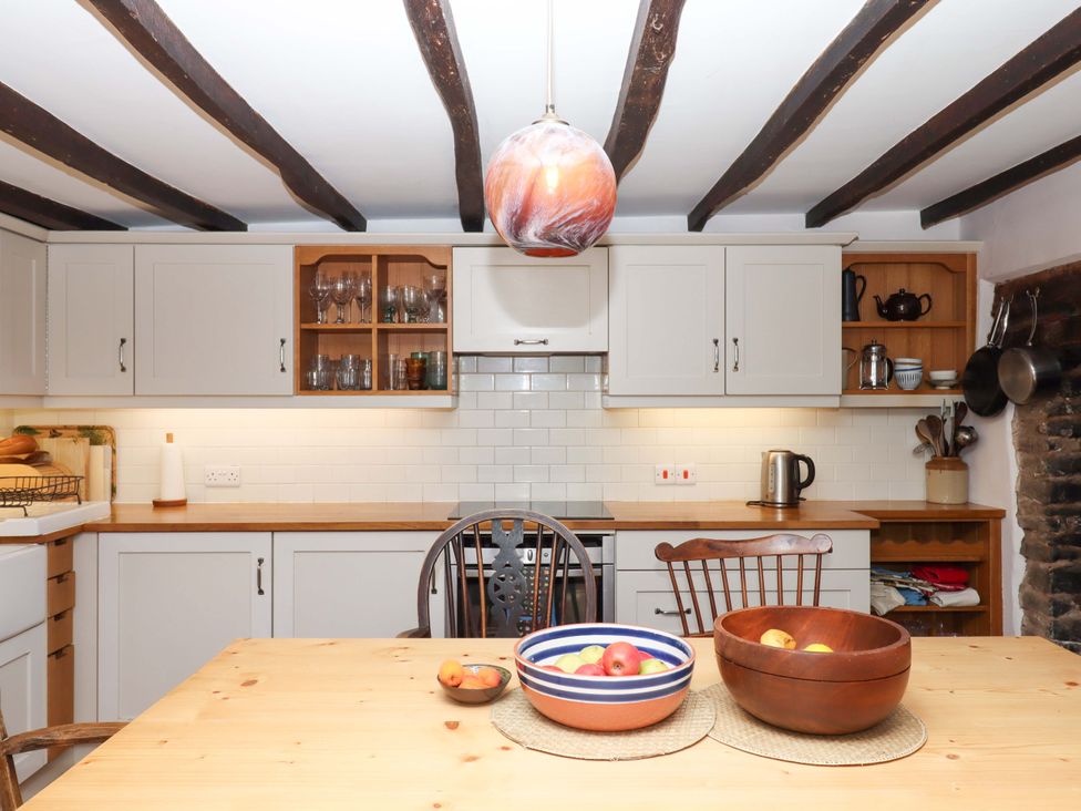 A kitchen with tables and chairs at Hope Cottage in Riddlecombe, near Winkleigh
