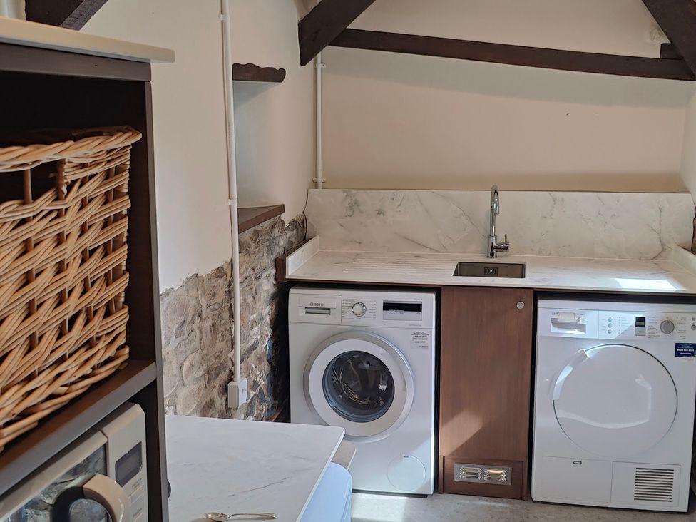 A laundry room with a washing machine and dryer at Hope Cottage in Riddlecombe, near Winkleigh