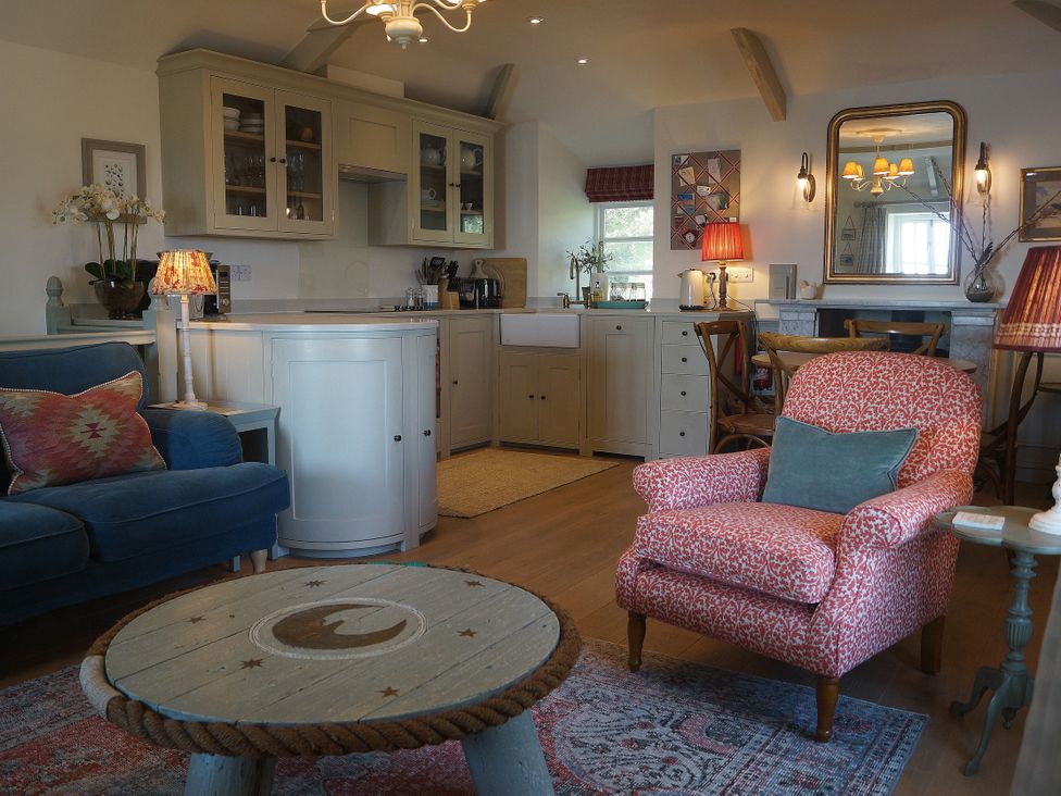 A living room with a sofa and coffee table at Coach House Cottage Strete, near Dartmouth