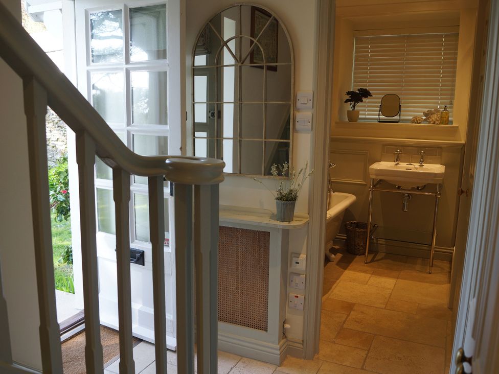 A bathroom featuring a sink and toilet at Coach House Cottage in Strete, near Dartmouth
