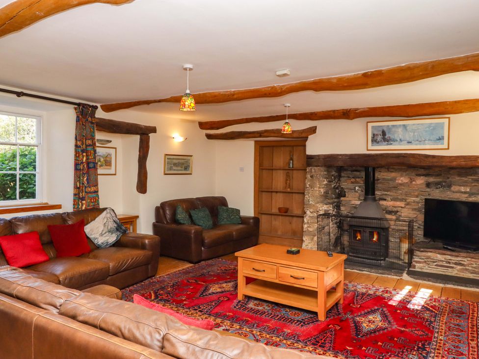 A living room with a fireplace and sofas at East Bickleigh in Halwell